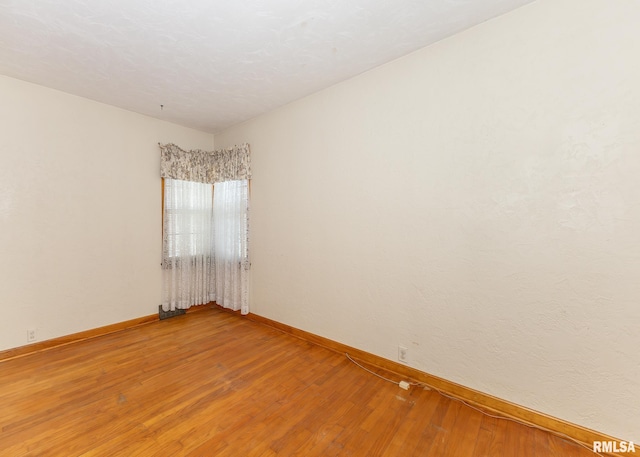 spare room with hardwood / wood-style floors