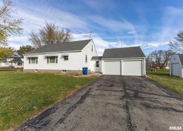 view of front of home with a garage and a front lawn