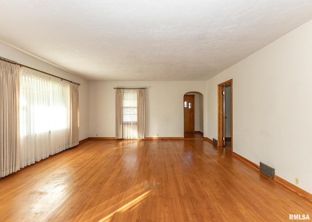 unfurnished room with light wood-type flooring