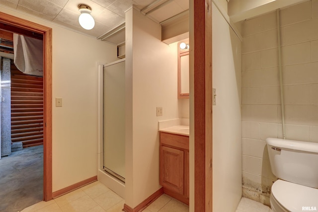 bathroom featuring vanity, an enclosed shower, and toilet