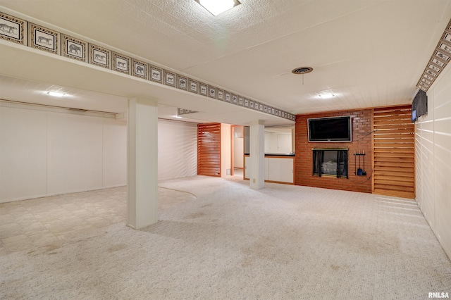 basement with carpet and a brick fireplace