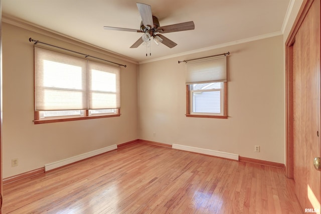 unfurnished bedroom featuring multiple windows, baseboard heating, crown molding, and ceiling fan