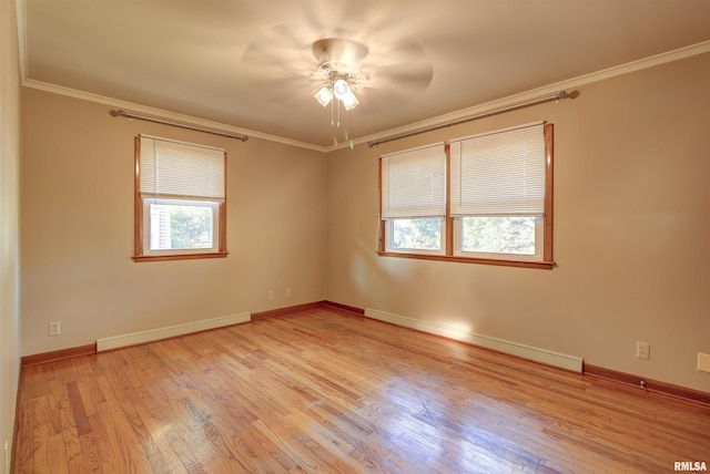 unfurnished room with ornamental molding, light wood-type flooring, plenty of natural light, and a baseboard heating unit