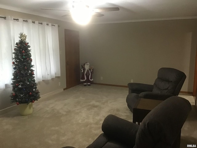 living area featuring ceiling fan, ornamental molding, and light carpet