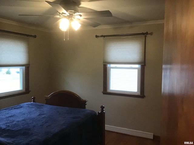 bedroom featuring hardwood / wood-style flooring, ceiling fan, and crown molding