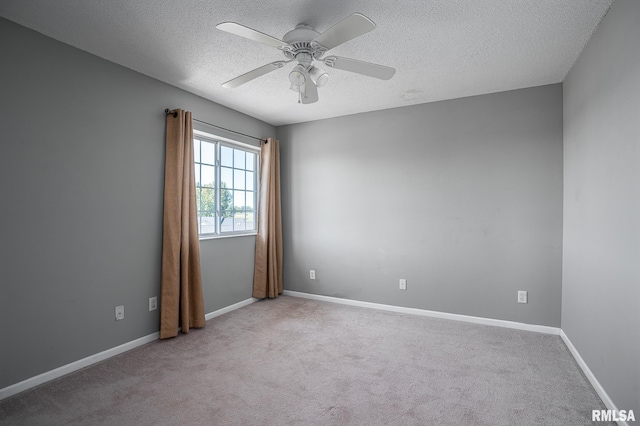 empty room featuring a textured ceiling, ceiling fan, and light colored carpet