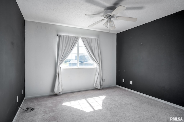 carpeted empty room featuring ceiling fan and a textured ceiling