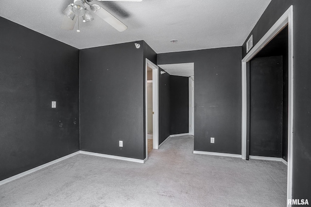 unfurnished bedroom featuring a closet, ceiling fan, light colored carpet, and a textured ceiling