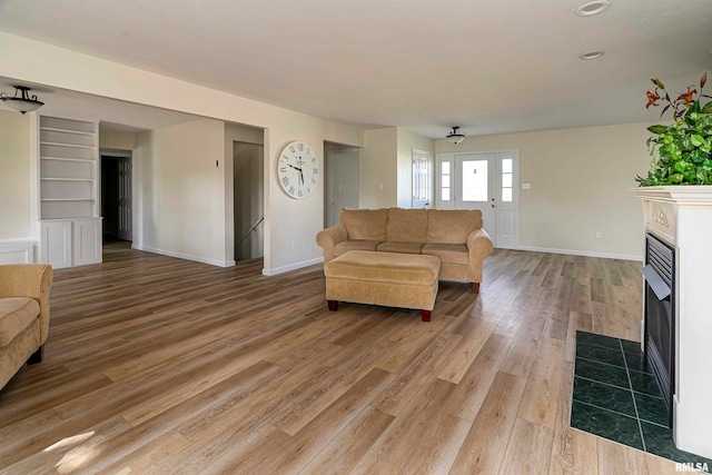 living room with ceiling fan and hardwood / wood-style flooring