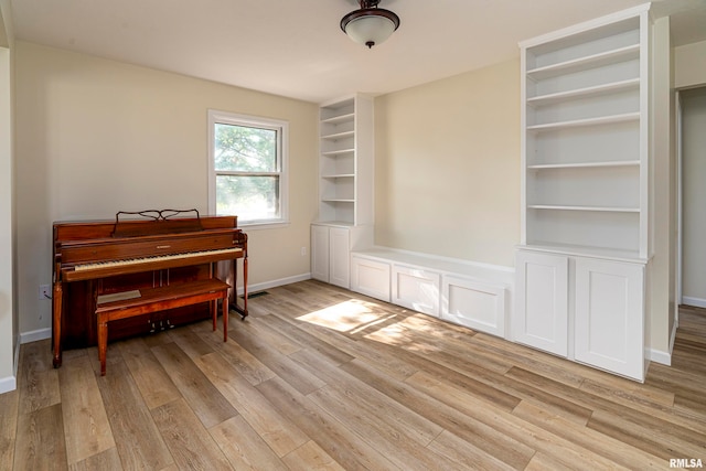 misc room featuring built in shelves and light hardwood / wood-style floors