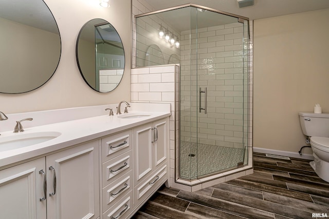 bathroom with vanity, toilet, and an enclosed shower