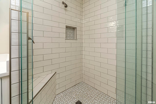 bathroom with tiled shower