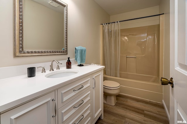 full bathroom featuring shower / tub combo, hardwood / wood-style floors, vanity, and toilet