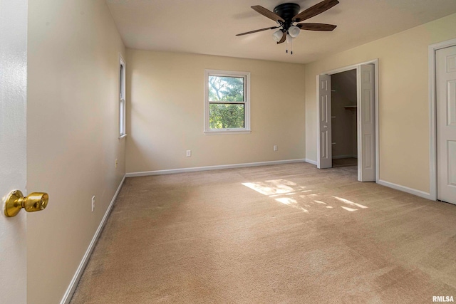 unfurnished room featuring light carpet and ceiling fan