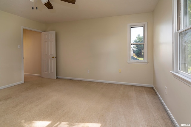 unfurnished room featuring light carpet and ceiling fan