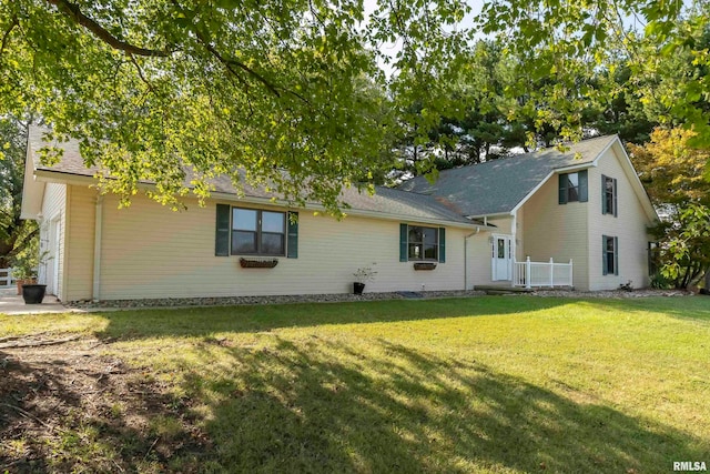 rear view of house with a yard