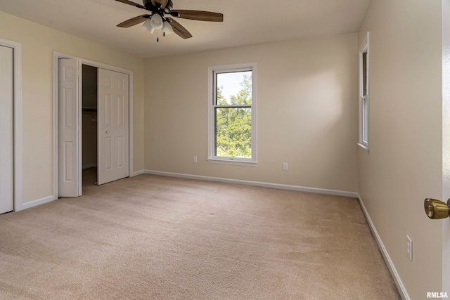 unfurnished bedroom featuring light carpet and ceiling fan