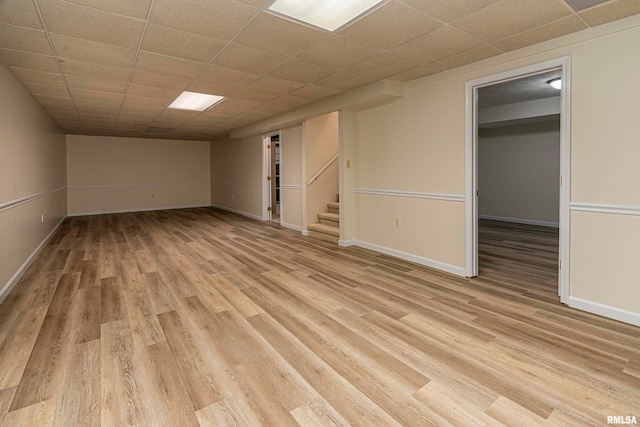 interior space featuring light hardwood / wood-style floors and a drop ceiling