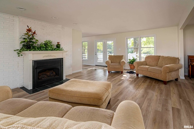 living room featuring wood-type flooring and brick wall