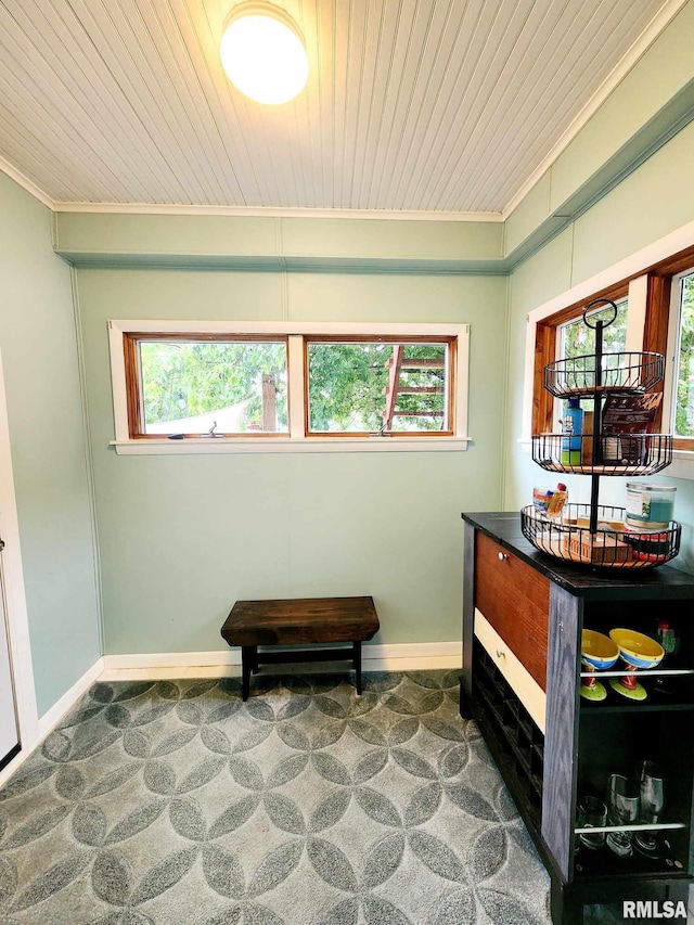 sitting room with wood ceiling, carpet floors, and a wealth of natural light