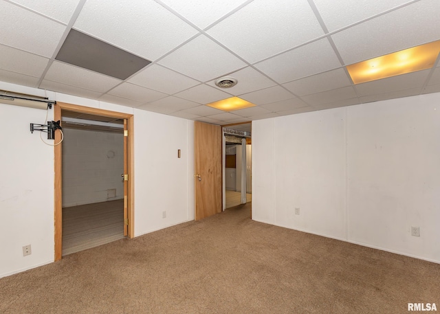 basement featuring carpet and a drop ceiling