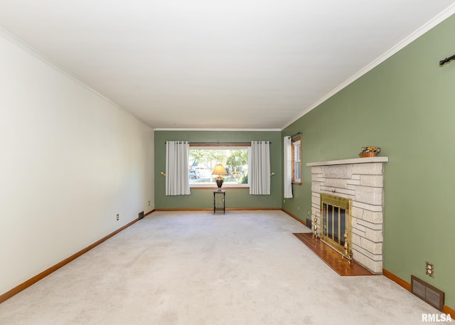 unfurnished living room with crown molding, a stone fireplace, and carpet flooring