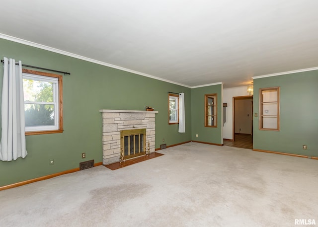 unfurnished living room featuring ornamental molding, a stone fireplace, and carpet