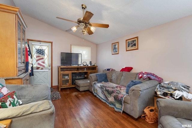 living room featuring lofted ceiling, ceiling fan, and dark hardwood / wood-style floors