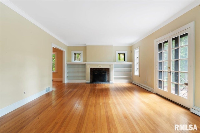 unfurnished living room with a fireplace, light wood-type flooring, and a wealth of natural light