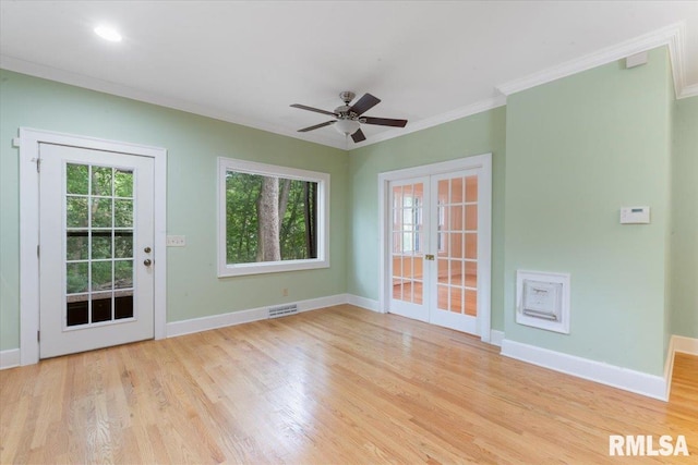 spare room featuring light hardwood / wood-style flooring, ceiling fan, french doors, and crown molding