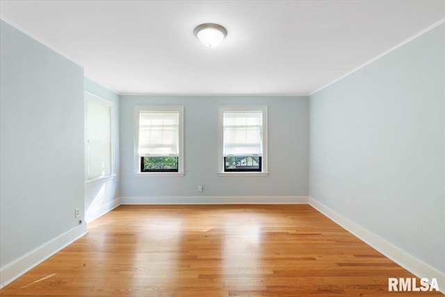 unfurnished room with ornamental molding and light hardwood / wood-style floors