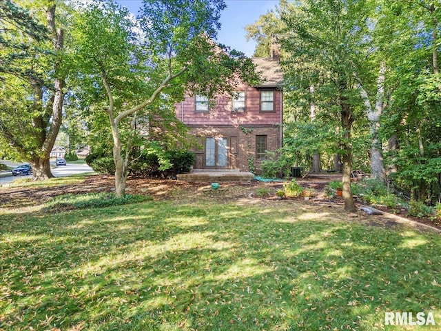 exterior space featuring central AC and a front lawn