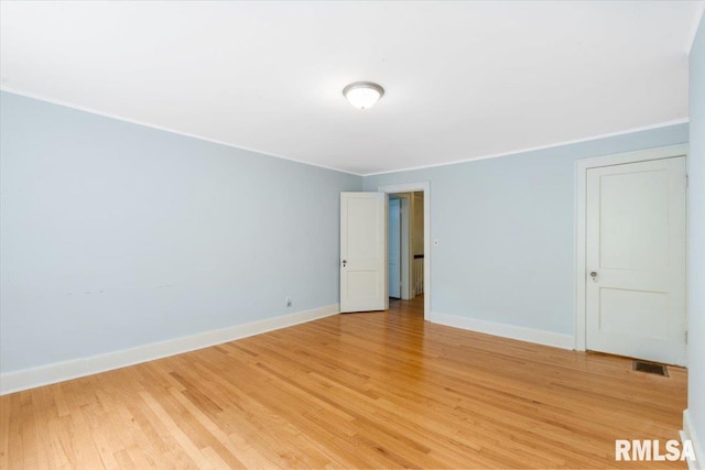 unfurnished room featuring light hardwood / wood-style flooring and ornamental molding