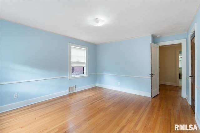 empty room with light hardwood / wood-style floors