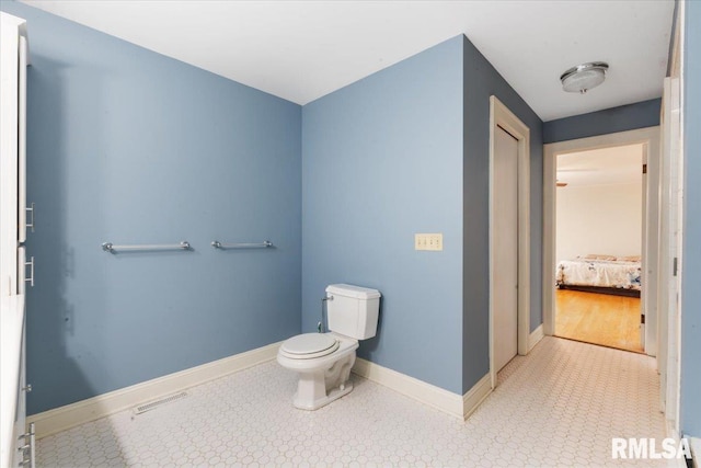 bathroom featuring hardwood / wood-style flooring and toilet