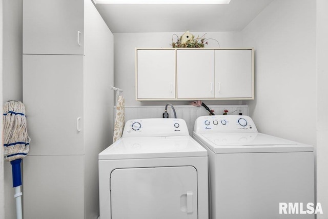 washroom with cabinets and independent washer and dryer