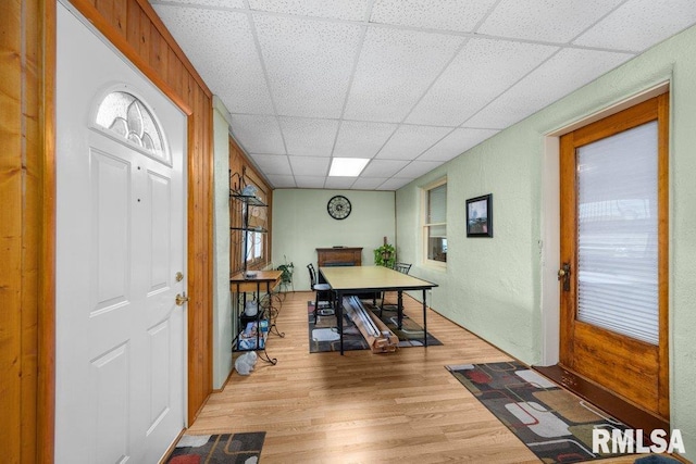 office featuring light wood-type flooring and a drop ceiling