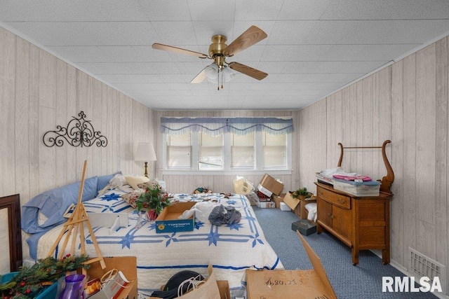 interior space featuring wooden walls and ceiling fan