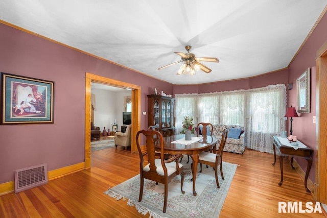 dining space with light hardwood / wood-style flooring and ceiling fan