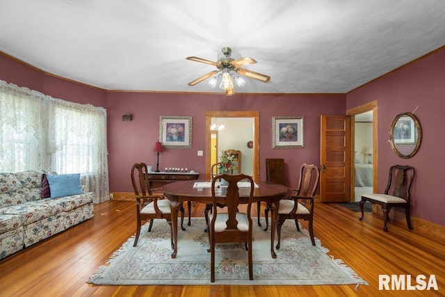 dining space with wood-type flooring and ceiling fan