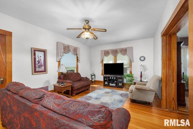 living room with ceiling fan and hardwood / wood-style floors