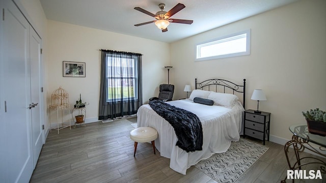 bedroom with wood-type flooring and ceiling fan