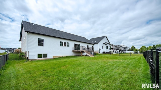 back of house with a lawn and a wooden deck