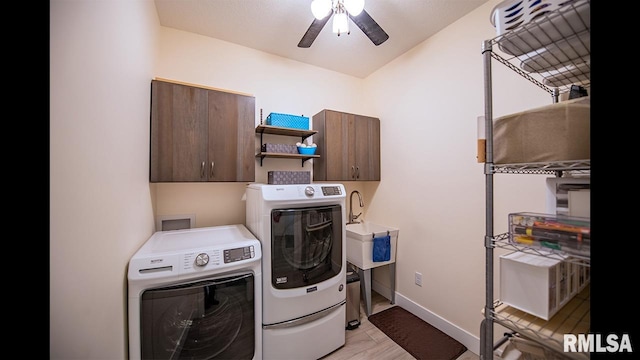 clothes washing area with cabinets, ceiling fan, and washing machine and dryer