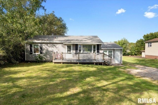 rear view of property featuring a yard and a deck