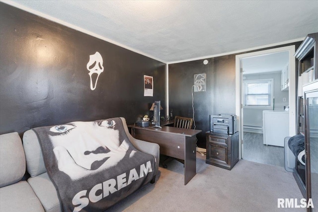 bedroom featuring light colored carpet, washer / clothes dryer, and a textured ceiling