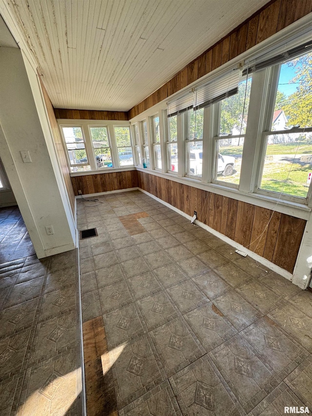 unfurnished sunroom featuring wooden ceiling