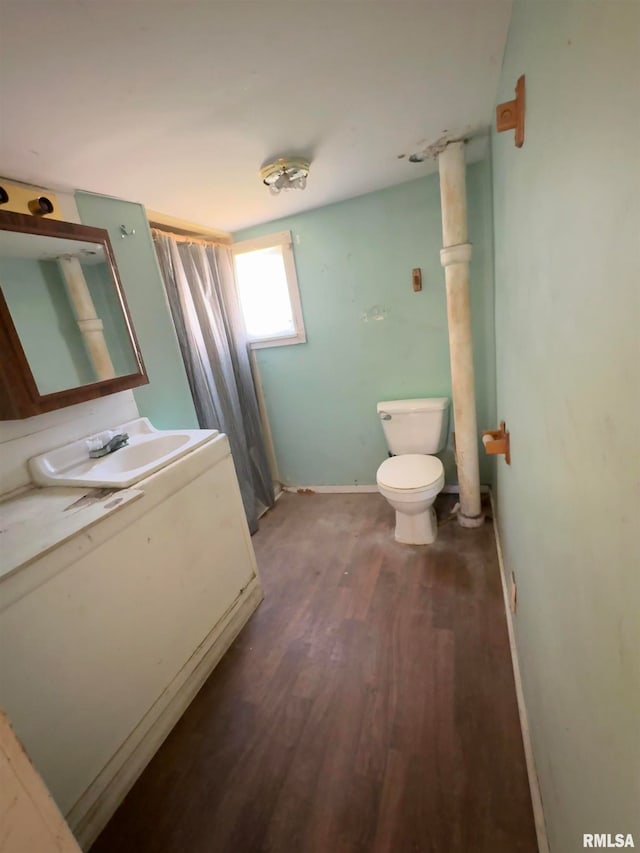 bathroom with hardwood / wood-style flooring, vanity, and toilet