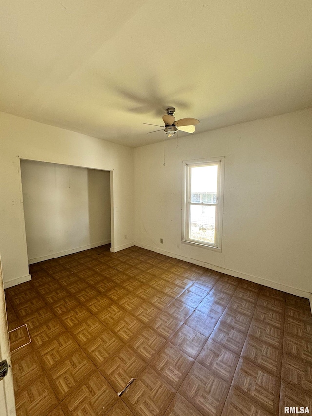 spare room with ceiling fan and light parquet floors