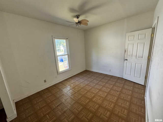 unfurnished room featuring ceiling fan and light parquet flooring